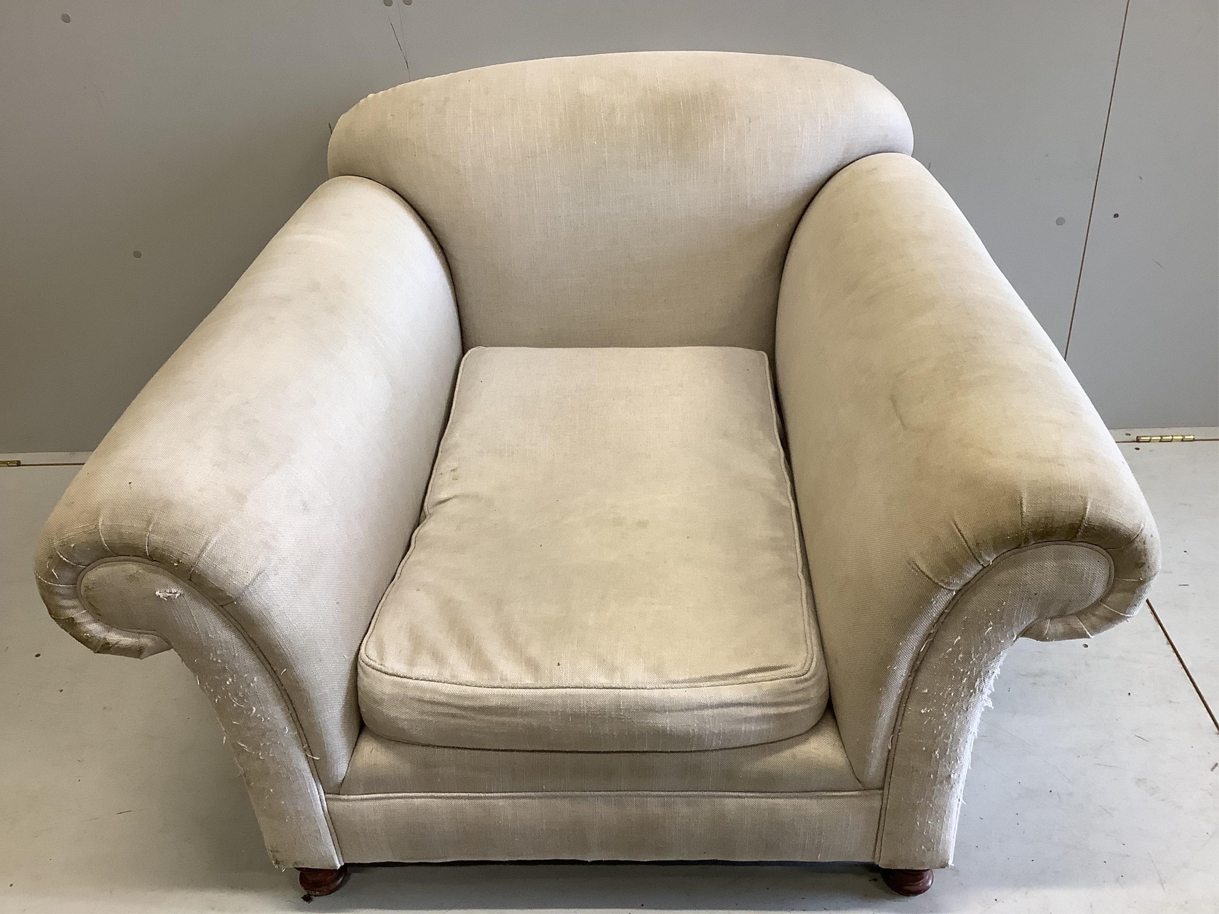 A Howard style upholstered armchair, width 115cm, depth 110cm, height 78cm. Condition - fair, upholstery scratched and requires cleaning